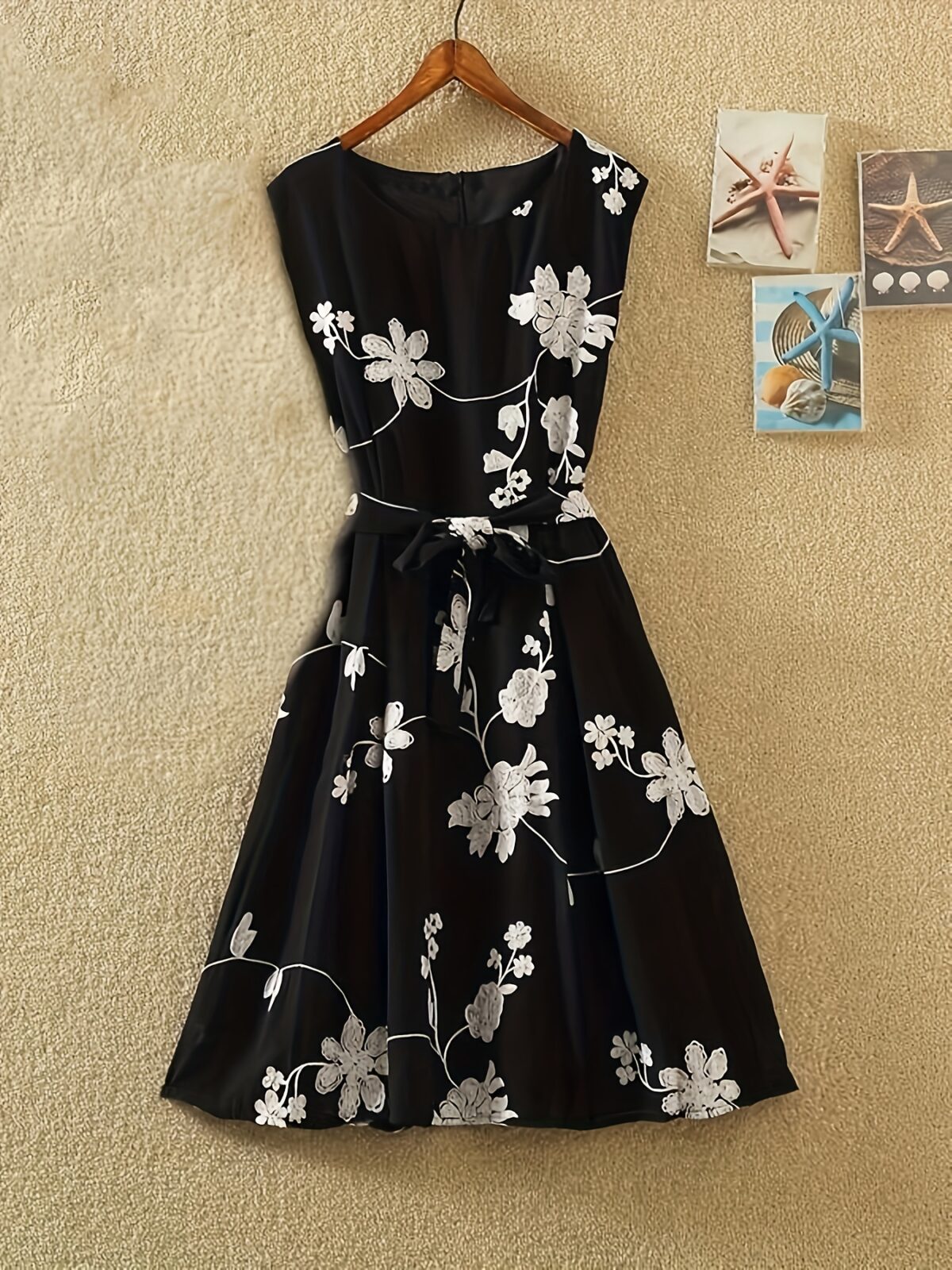 Model wearing the Newness Summer Solstice Floral Print Dress a chic and flattering midi dress with a retro inspired floral print perfect for summer