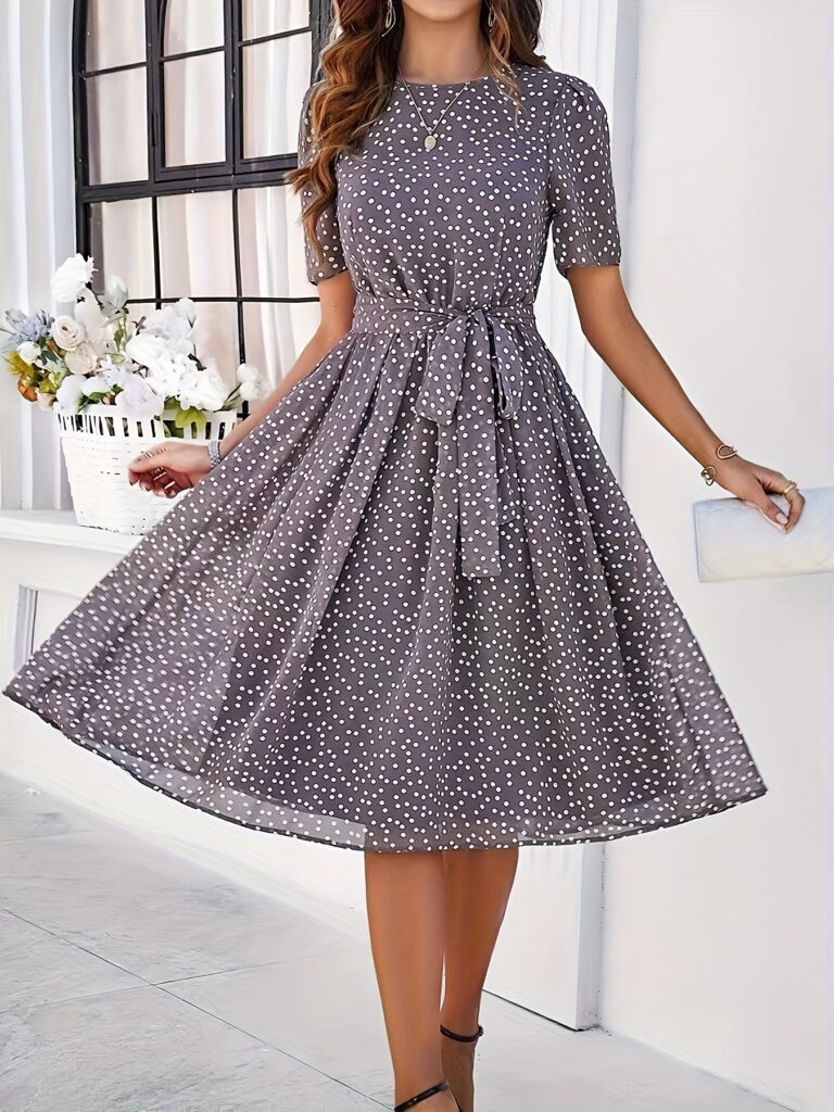 Timeless Polka Dot Swing Dress in a flattering A-line silhouette. Perfect for spring and summer.