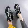 Pair of stylish thick soled womens casual sport shoes in a trendy color shown from the side