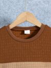 Stylish boys two piece outfit featuring a comfortable long sleeved knit pullover and trendy cargo pants perfect for spring and fall adventures