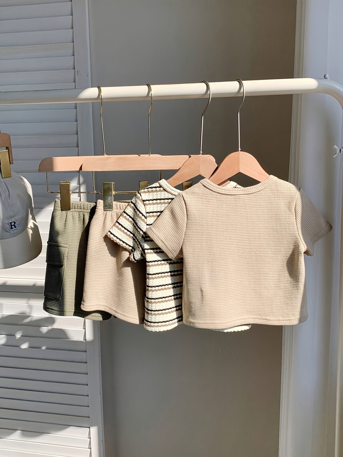 Adorable baby boy in a beige and green striped summer outfit set featuring a textured short sleeve top and matching shorts Perfect for warm weather