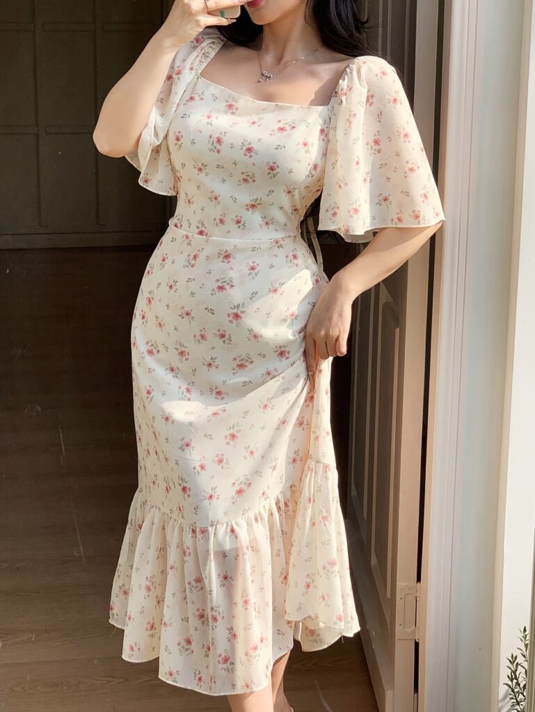 Effortlessly chic Newness Casablanca Floral Maxi Dress, perfect for weddings, brunch, or everyday elegance. Model wears a flowing floral maxi dress with a flattering silhouette.