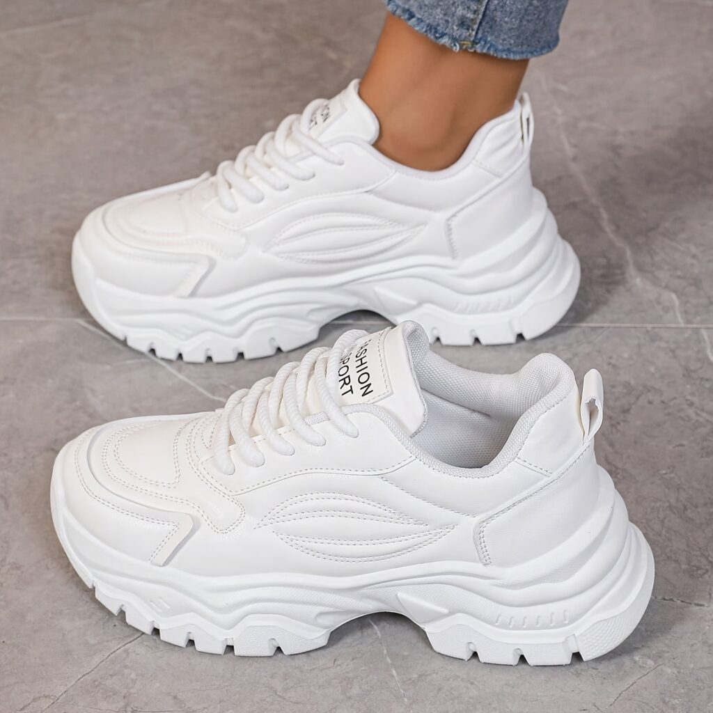 White women's chunky sneakers with geometric embroidery, thick sole, and lace-up closure.