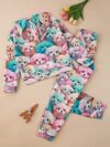 Adorable girl wearing a playful spring hues hooded sports suit featuring a charming cartoon print Perfect for spring adventures