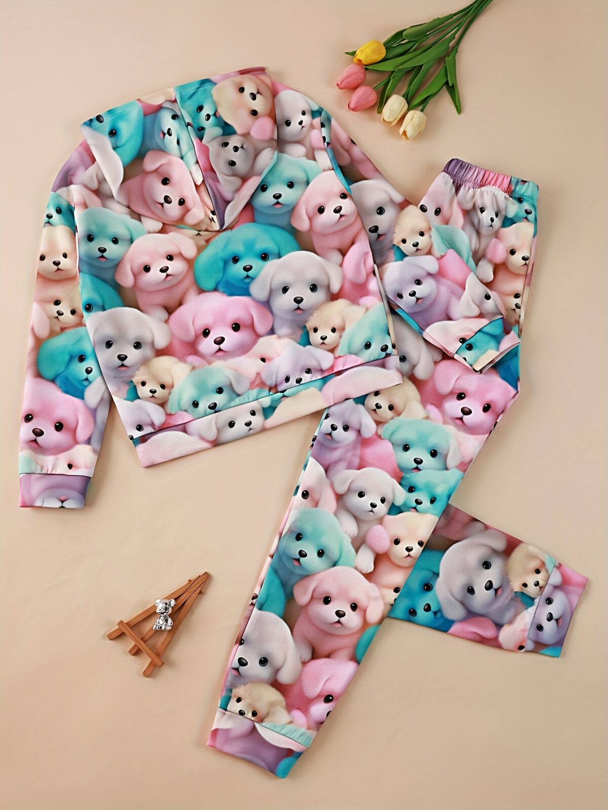 Adorable girl wearing a playful spring hues hooded sports suit featuring a charming cartoon print Perfect for spring adventures