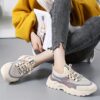 Pair of stylish thick soled womens casual sport shoes in a trendy color shown from the side