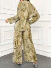 Model showcasing the Newness Effortless Chic Tie Dye Pantsuit a stylish spring ensemble featuring a vibrant tie dye pattern on both the pants and matching blazer The pantsuit exudes effortless sophistication and chic style
