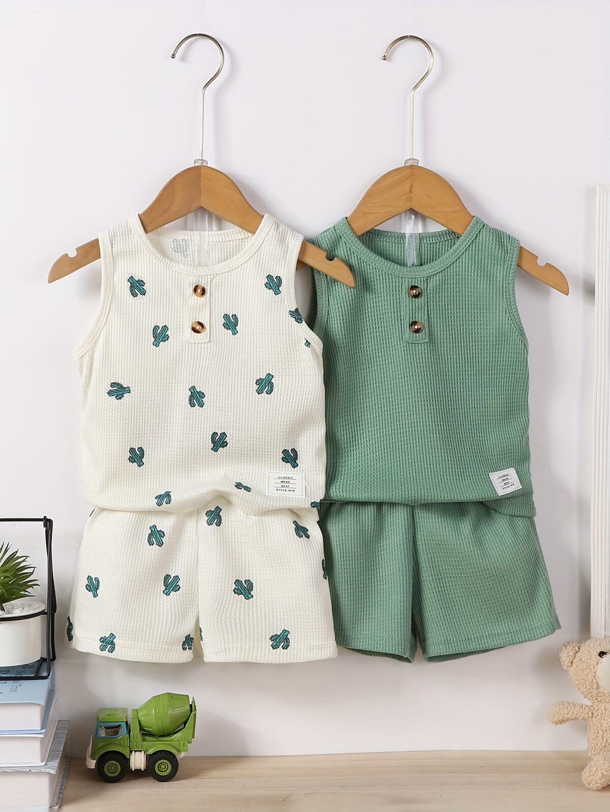 Adorable baby boy in a trendy Newness cactus print outfit featuring a waffle knit vest and pants Perfect summer clothes