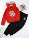 Adorable girl wearing a playful spring hues hooded sports suit featuring a charming cartoon print Perfect for spring adventures
