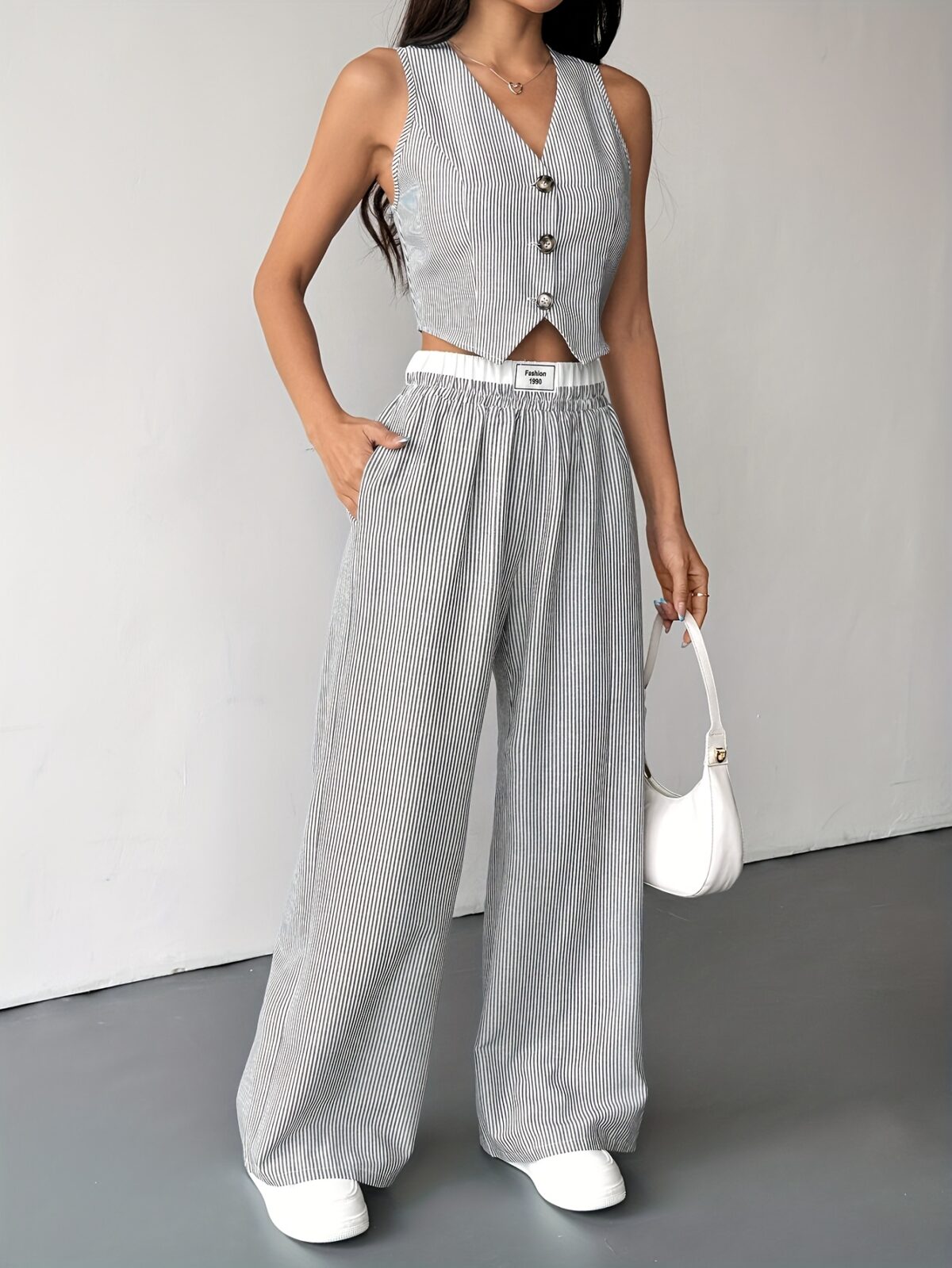 The Newness Riviera Striped Trouser Set in a flattering pose showcasing its relaxed fit and chic style Model is wearing the matching top and trousers