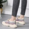 Pair of stylish thick soled womens casual sport shoes in a trendy color shown from the side