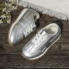 Stylish silvery gray and white low top sneakers for kids featuring a durable TPR sole breathable lining and secure lace up closure Perfect for everyday wear