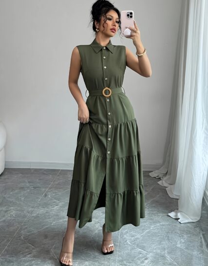 Model wearing the Newness Cairo Nights Geometric Print Dress a chic belted dress perfect for summer featuring a striking geometric print