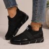 Womens black slip on sneakers with golden accents showcasing the breathable knit upper and flexible sole