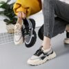 Pair of womens breathable mesh casual sneakers in white low top design with lace up closure and soft knit insole