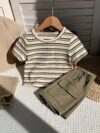 Adorable baby boy in a beige and green striped summer outfit set featuring a textured short sleeve top and matching shorts Perfect for warm weather