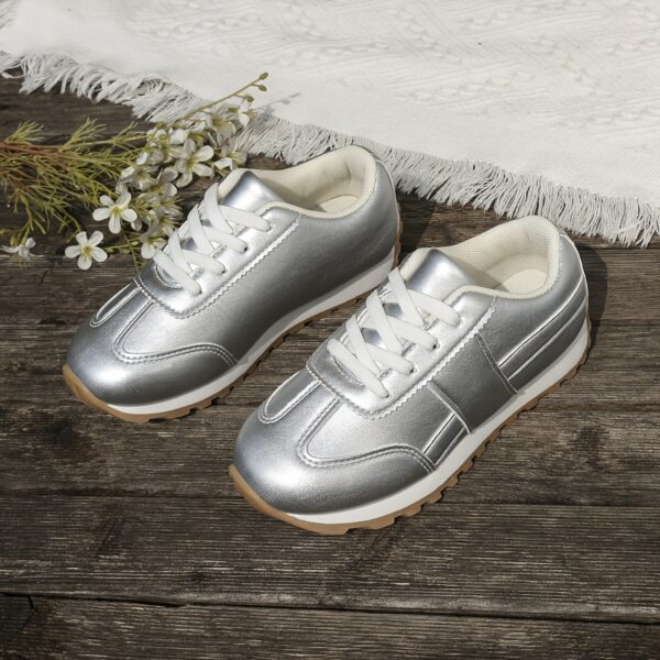 Stylish silvery gray and white low top sneakers for kids featuring a durable TPR sole breathable lining and secure lace up closure Perfect for everyday wear