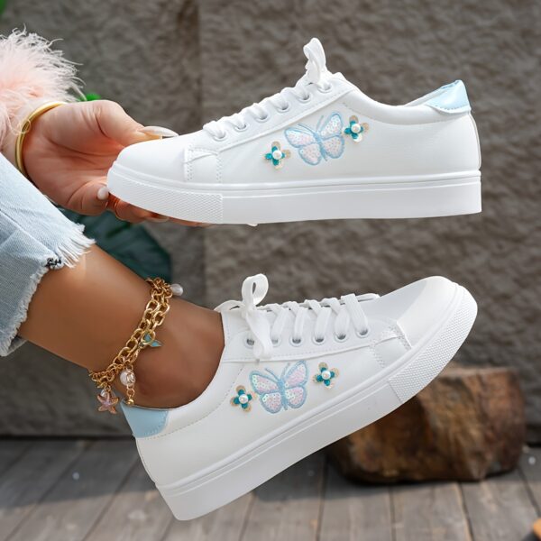 Newness Blush Butterfly Lace-Up Sneakers: Chic blush-colored sneakers with butterfly accents and lace-up closure, perfect for spring.