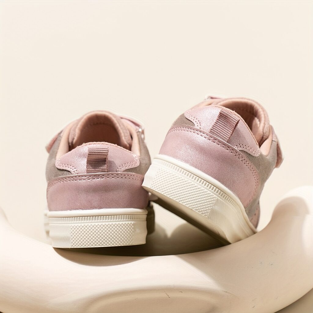 Adorable girls' twinkle toes sneakers in pink with heart embellishments, featuring a soft, non-slip rubber sole, perfect for spring and fall.