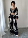 Effortlessly chic Casablanca Ethnic Print Set from Newness featuring a backless top and wide leg pants Model showcases the two piece outfit