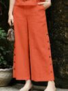 Embrace effortless chic in the Marrakech Sunset Embroidered Summer Jumpsuit This vibrant orange jumpsuit features intricate butterfly embroidery and a flattering wide leg silhouette