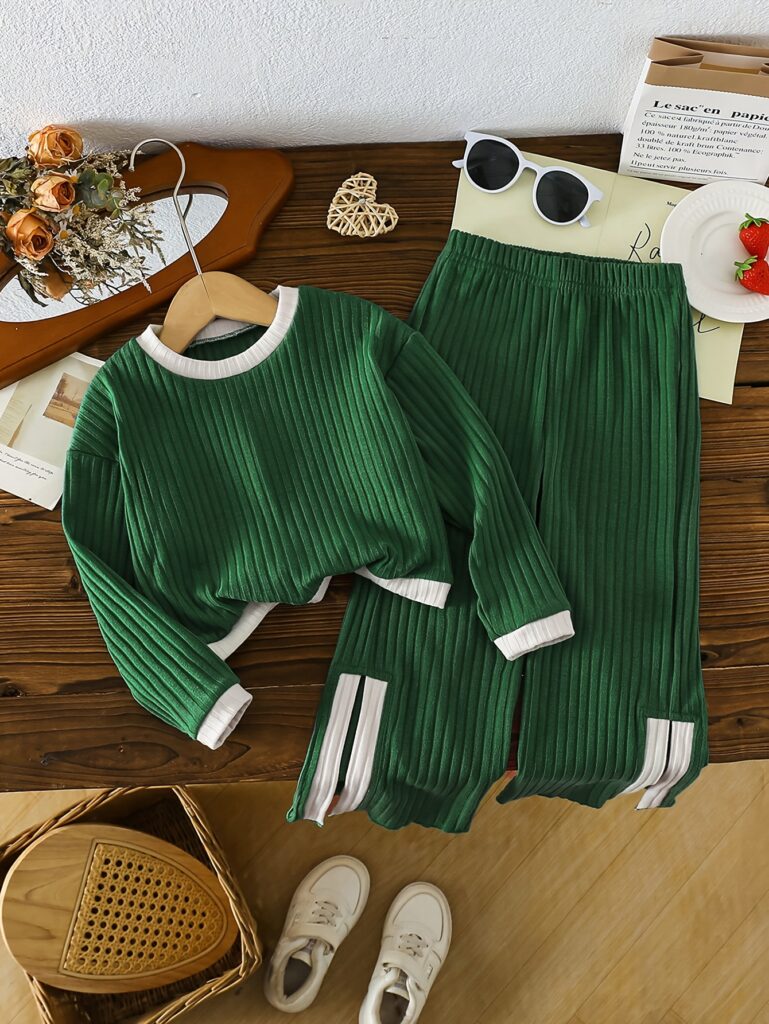 Girls' casual sportswear set in soft polyester, perfect for playtime and everyday wear. Shown in a playful pose.