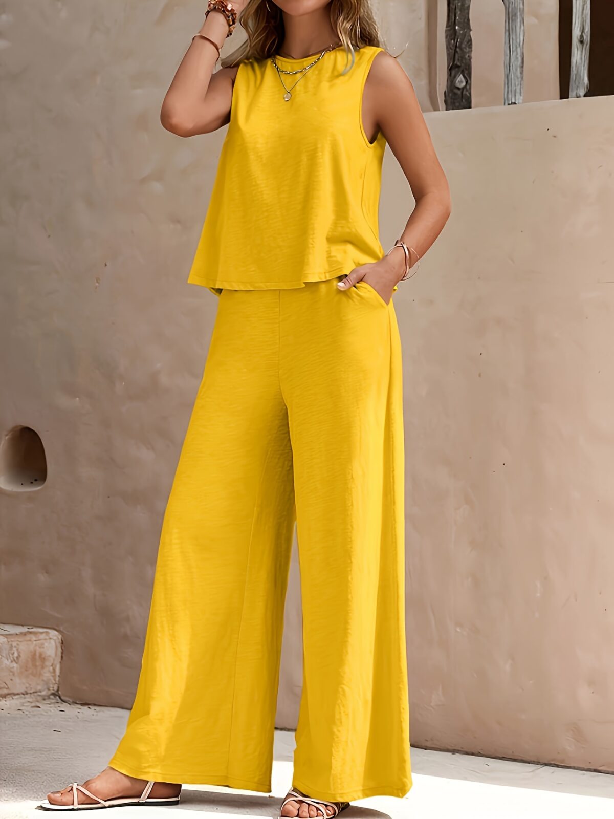 The Newness Cairo Sleeveless Wide Leg Set in white featuring a relaxed sleeveless top and wide leg pants perfect for a spring or summer day