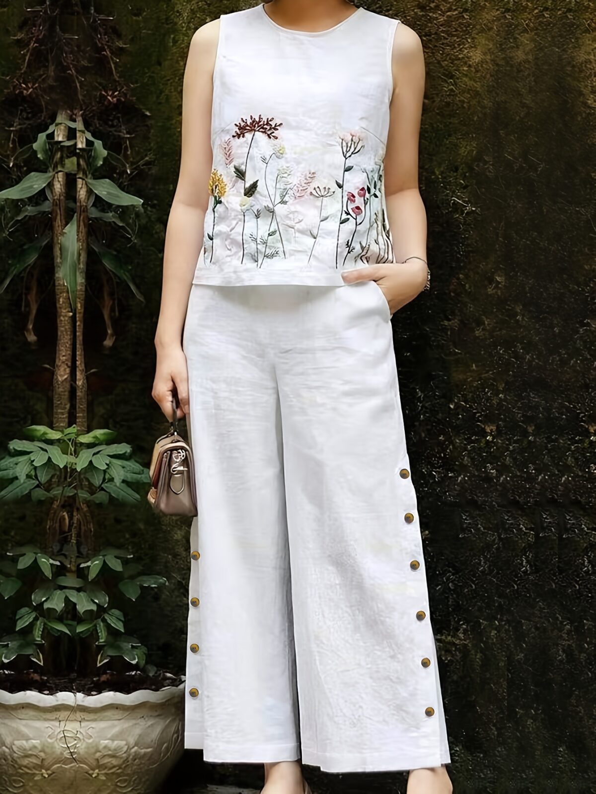 Embrace effortless chic in the Marrakech Sunset Embroidered Summer Jumpsuit This vibrant orange jumpsuit features intricate butterfly embroidery and a flattering wide leg silhouette