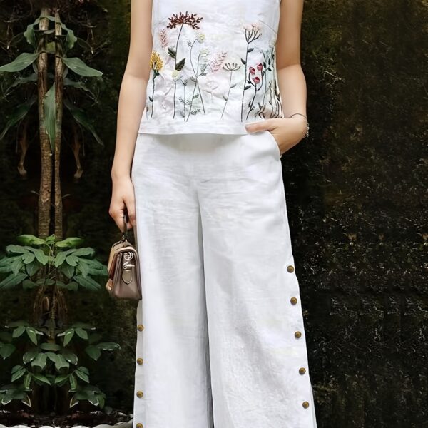 Embrace effortless chic in the Marrakech Sunset Embroidered Summer Jumpsuit This vibrant orange jumpsuit features intricate butterfly embroidery and a flattering wide leg silhouette