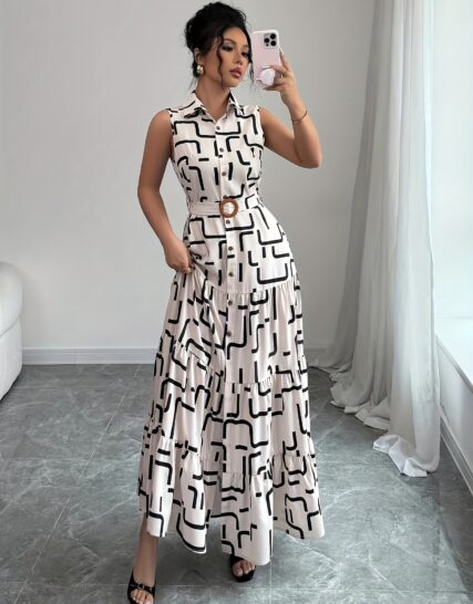Model wearing the Newness Cairo Nights Geometric Print Dress, a chic belted dress perfect for summer, featuring a striking geometric print.
