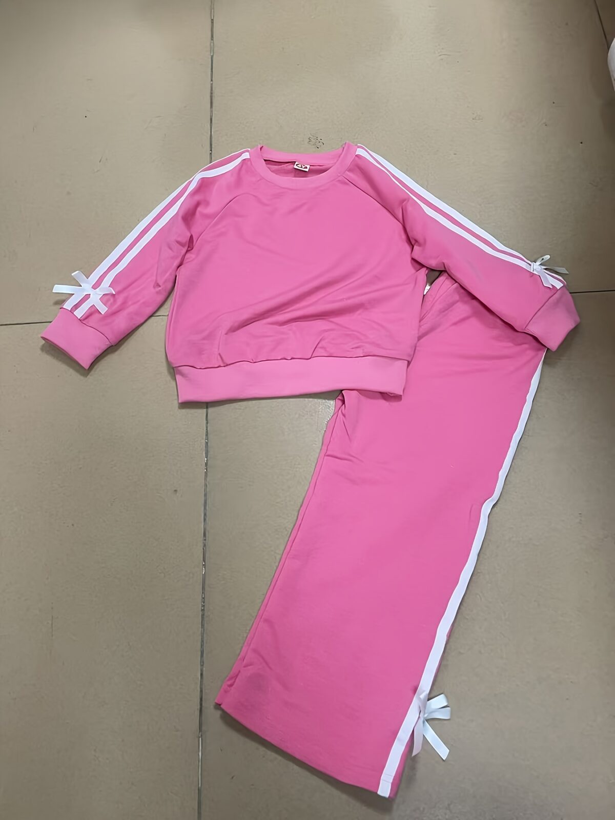 Girl wearing a stylish and comfortable two piece sweatpants set in soft stretchy fabric Perfect for everyday wear