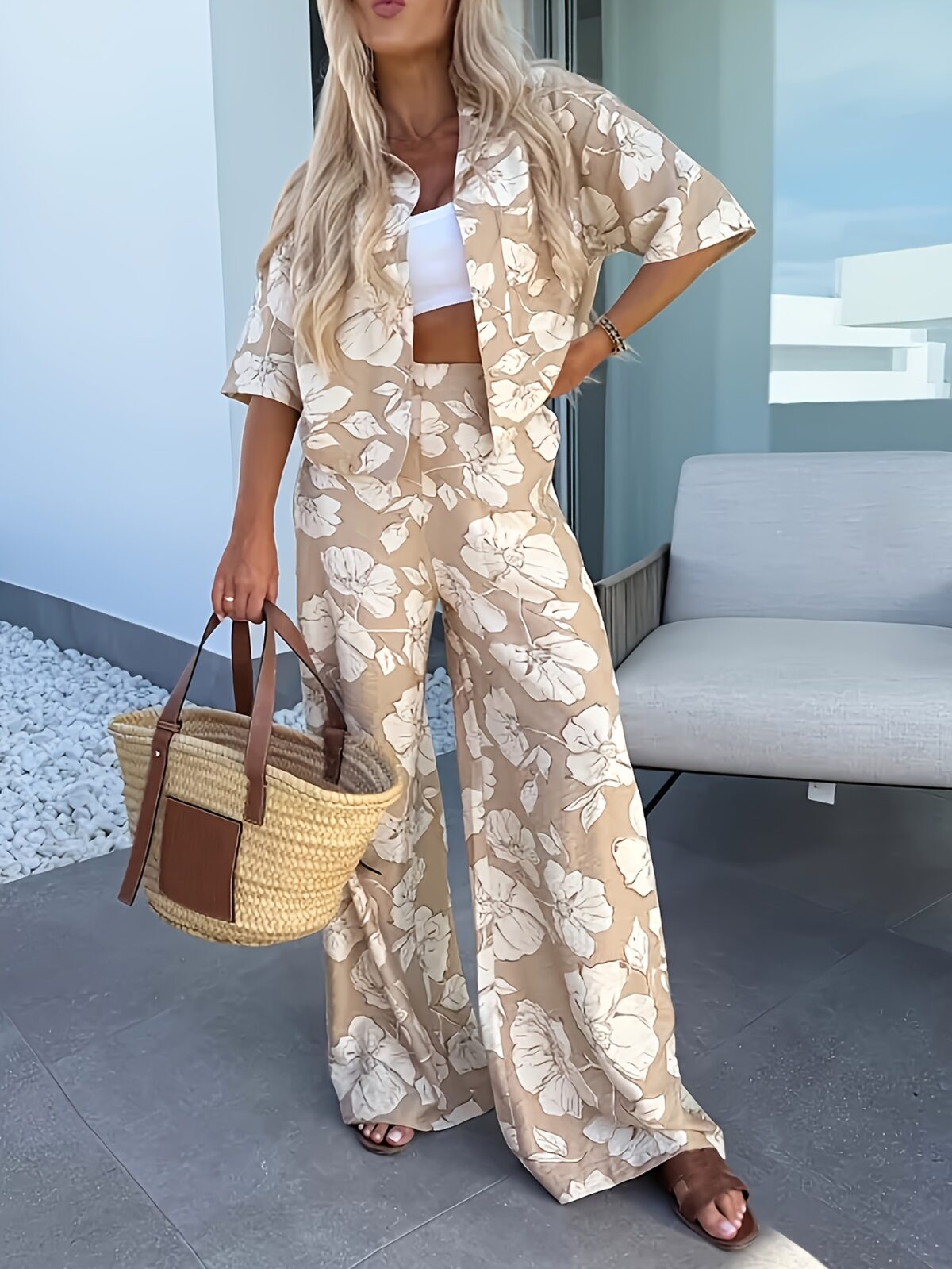 Stylish woman wearing the Newness Summer Breeze Floral Print Set posing outdoors in summery lighting The set includes a flowy top and coordinating shorts or skirt showcasing the beautiful floral print