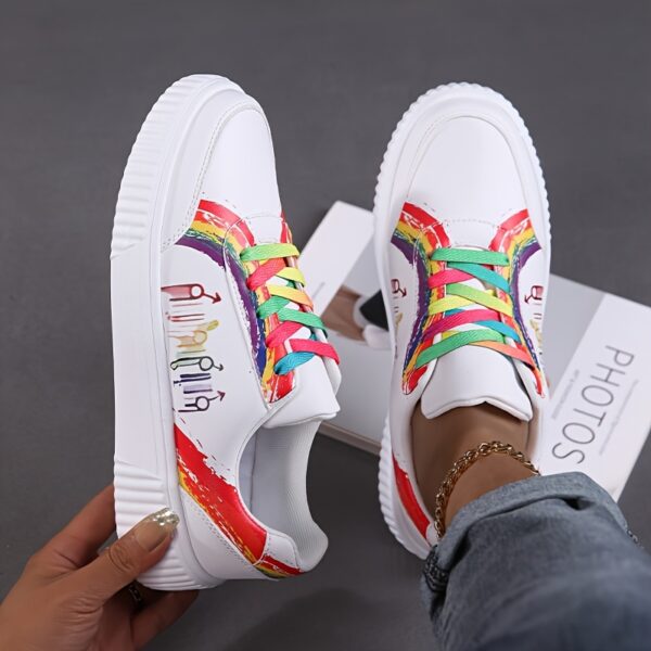 Newness Rainbow Burst Sneakers Chic comfort redefined A pair of vibrant rainbow striped sneakers showcasing their stylish design and comfortable fit