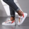 Newness Rainbow Burst Sneakers Chic comfort redefined A pair of vibrant rainbow striped sneakers showcasing their stylish design and comfortable fit
