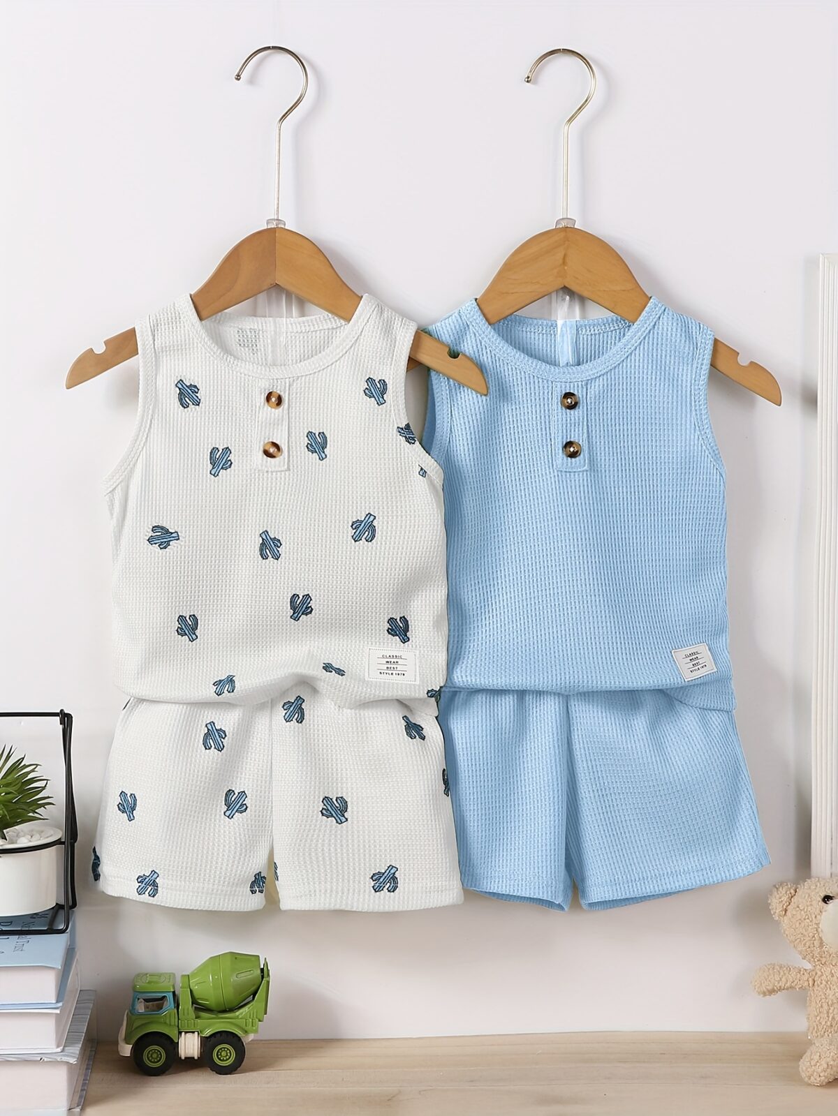 Adorable baby boy in a trendy Newness cactus print outfit featuring a waffle knit vest and pants Perfect summer clothes