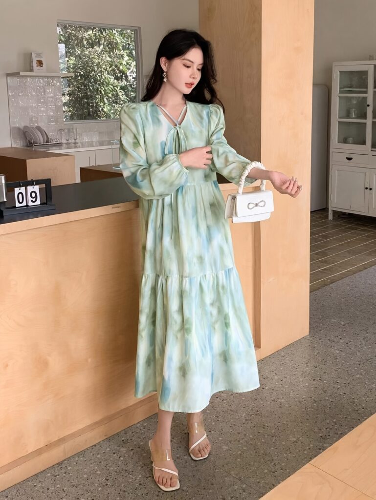 Casablanca Floral Print Dress from Newness. A stunning floral midi dress perfect for spring and fall, shown on a model.