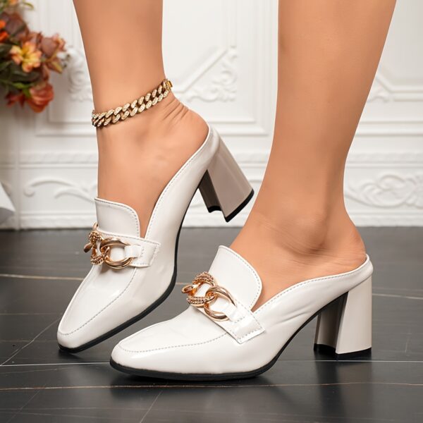Black square-toe pumps with a delicate chain detail and a comfortable block heel. Newness Timeless Chic collection.