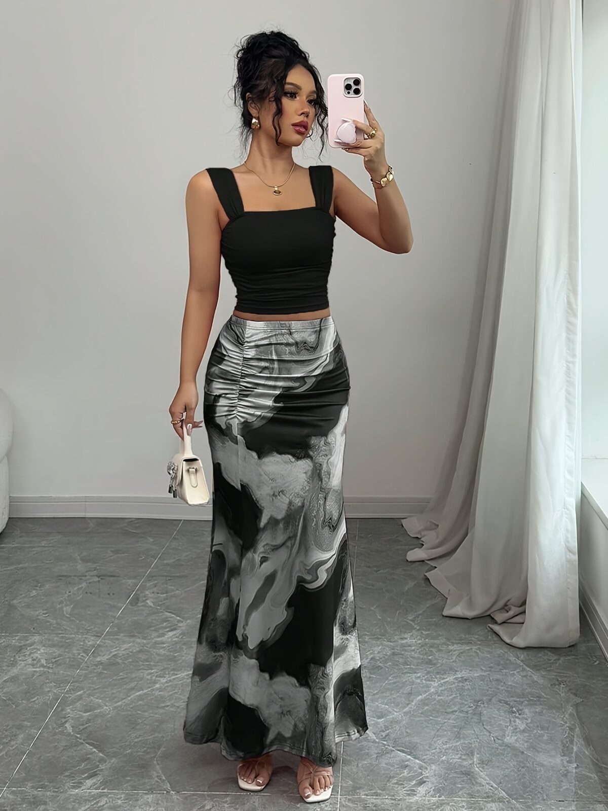 Model wearing the Newness Sunset Hues Ombre Skirt Set a chic two piece outfit featuring a gradient ombre effect in sunset colors The set includes a matching top and skirt showcasing a sophisticated and effortlessly cool summer style