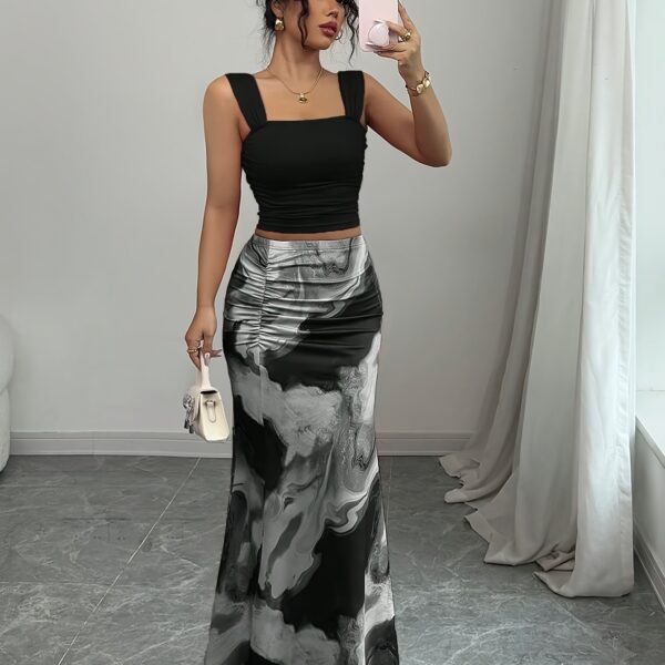 Model wearing the Newness Sunset Hues Ombre Skirt Set, a chic two-piece outfit featuring a gradient ombre effect in sunset colors. The set includes a matching top and skirt, showcasing a sophisticated and effortlessly cool summer style.