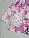 Stylish woman wearing a vibrant floral print blazer jacket relaxed fit showcasing the sophisticated tailoring and chic design of the Newness Botanical Bloom Blazer