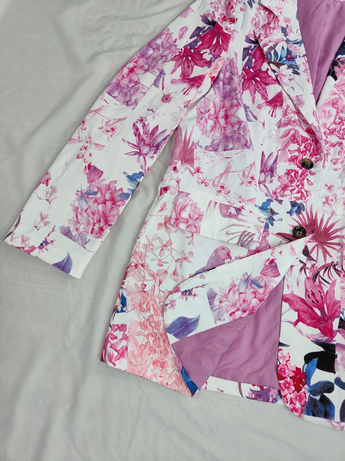 Stylish woman wearing a vibrant floral print blazer jacket relaxed fit showcasing the sophisticated tailoring and chic design of the Newness Botanical Bloom Blazer