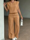 Model wearing the Newness Effortless Chic Sleeveless Wide Leg Set a stylish and comfortable two piece outfit featuring a sleeveless top and wide leg pants in luxurious polyester