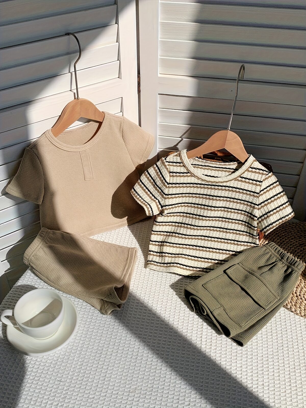 Adorable baby boy in a beige and green striped summer outfit set featuring a textured short sleeve top and matching shorts Perfect for warm weather