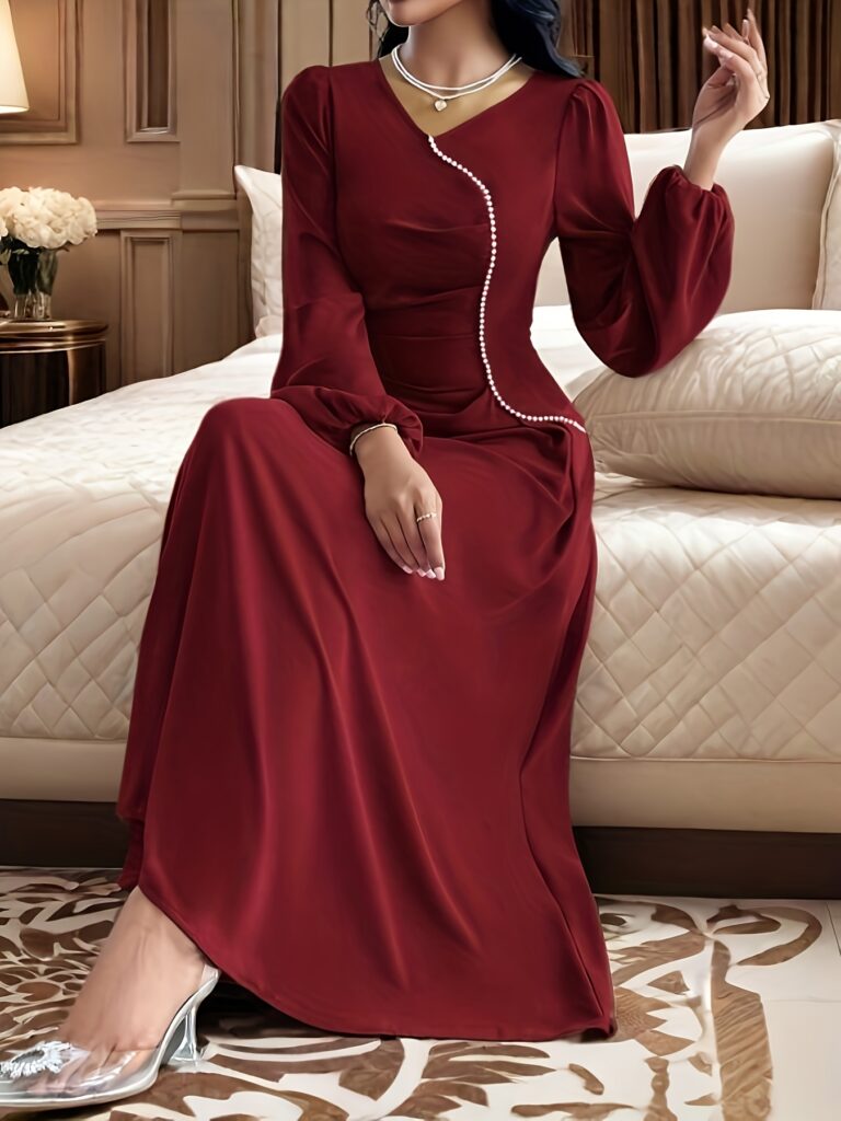 Crimson Elegance Beaded Maxi Dress from Newness. A flowing, elegant crimson maxi dress adorned with delicate beading, perfect for special occasions.