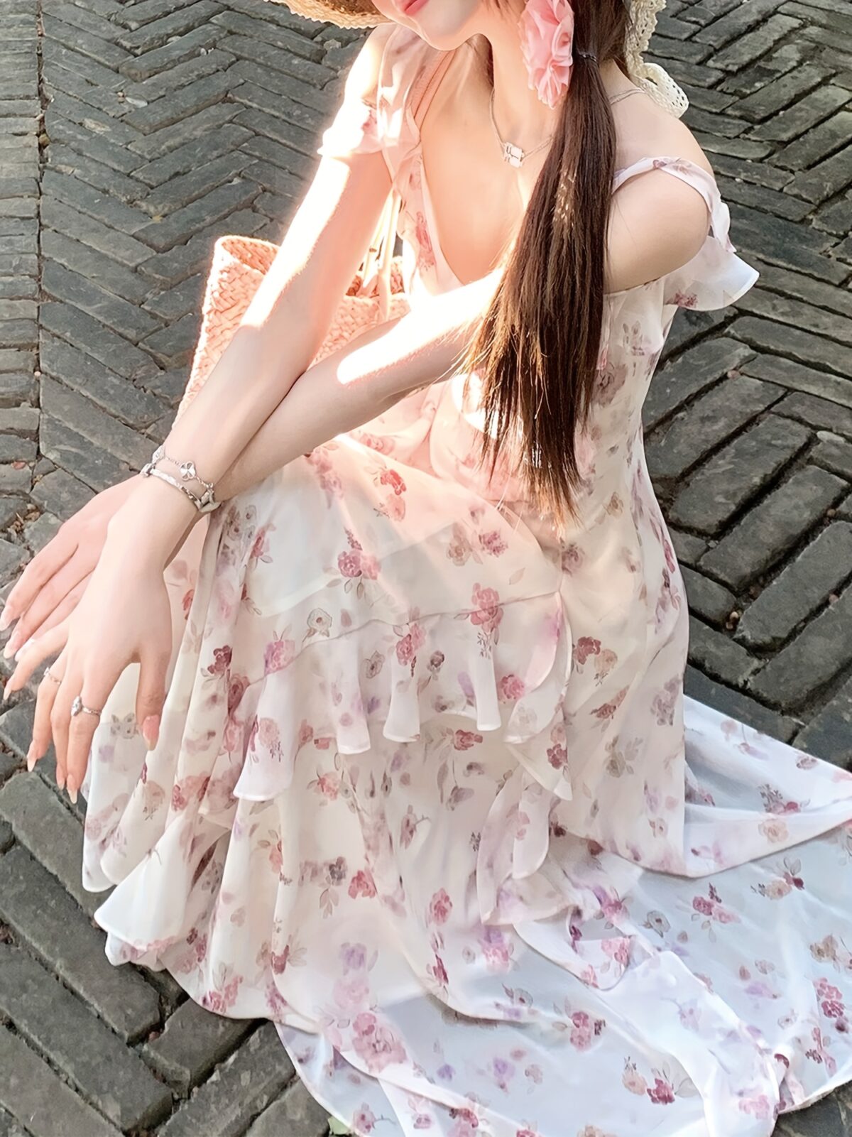 Model wearing a stunning Newness Summer Solstice Floral Print Maxi Dress showcasing its lightweight chiffon fabric asymmetrical hemline and beautiful floral print The dress flows gracefully