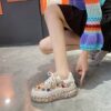 Elevate your style with Newnesss Elevated Rhinestone Platform Sneakers These hand stitched sneakers feature genuine gemstones and a chic platform sole