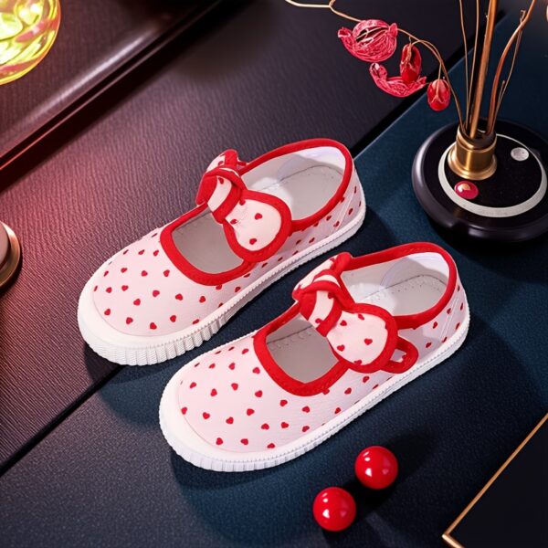 Adorable girls canvas sneakers in white adorned with a charming heart pattern and accented with cute red bows Perfect for spring summer or fall