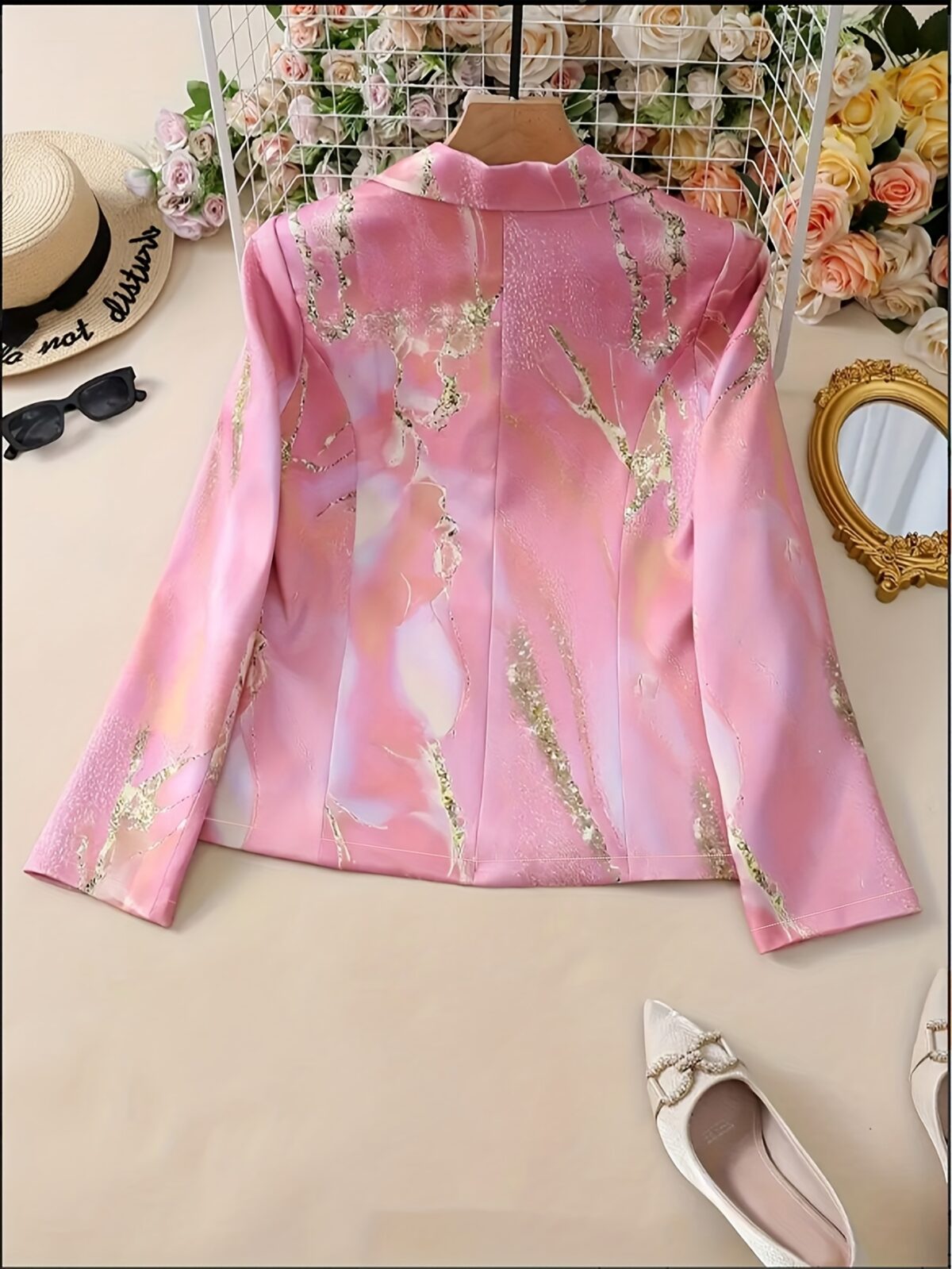 Stylish womens pink floral print blazer with golden accents shown in a loose fit Perfect for spring summer fall or winter