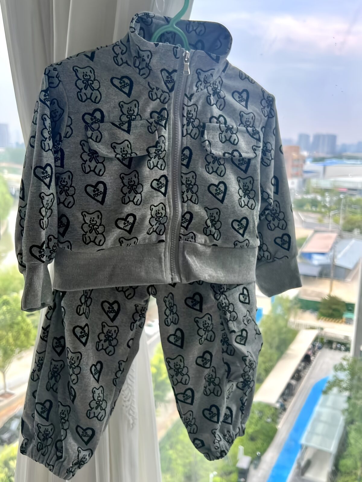 Girl wearing a stylish and windproof Newness Safari Dreams animal print set perfect for outdoor adventures