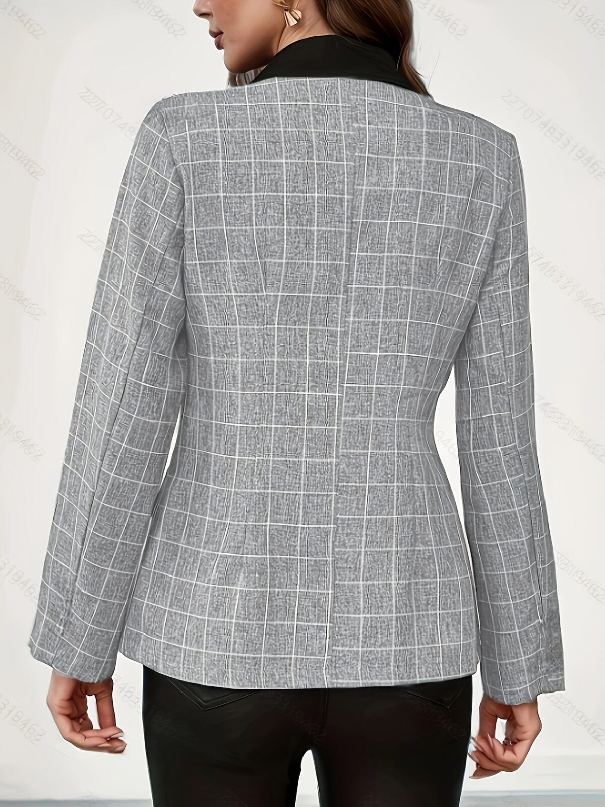 Stylish woman modeling a chic autumn plaid double breasted blazer showcasing its slim fit and long sleeves